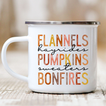 Load image into Gallery viewer, Picture of 12 ounce white enamel camp mug with graphic Flannels, hayrides, pumpkins, sweaters, bonfires. Each letter in muted  fall colors
