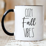 Load image into Gallery viewer, Picture of 11oz. Black handle Coffee mug with Cozy Fall Vibes in black letters
