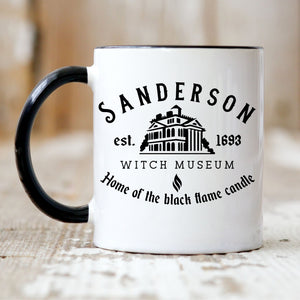Picture of our 11oz Black Handle Coffee Mug with Graphic of Sanderson Witch Museum on front of mug.
