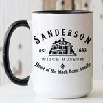 Load image into Gallery viewer, Picture of our 15oz Black Handle Coffee Mug with Graphic of Sanderson Witch Museum on front of mug.
