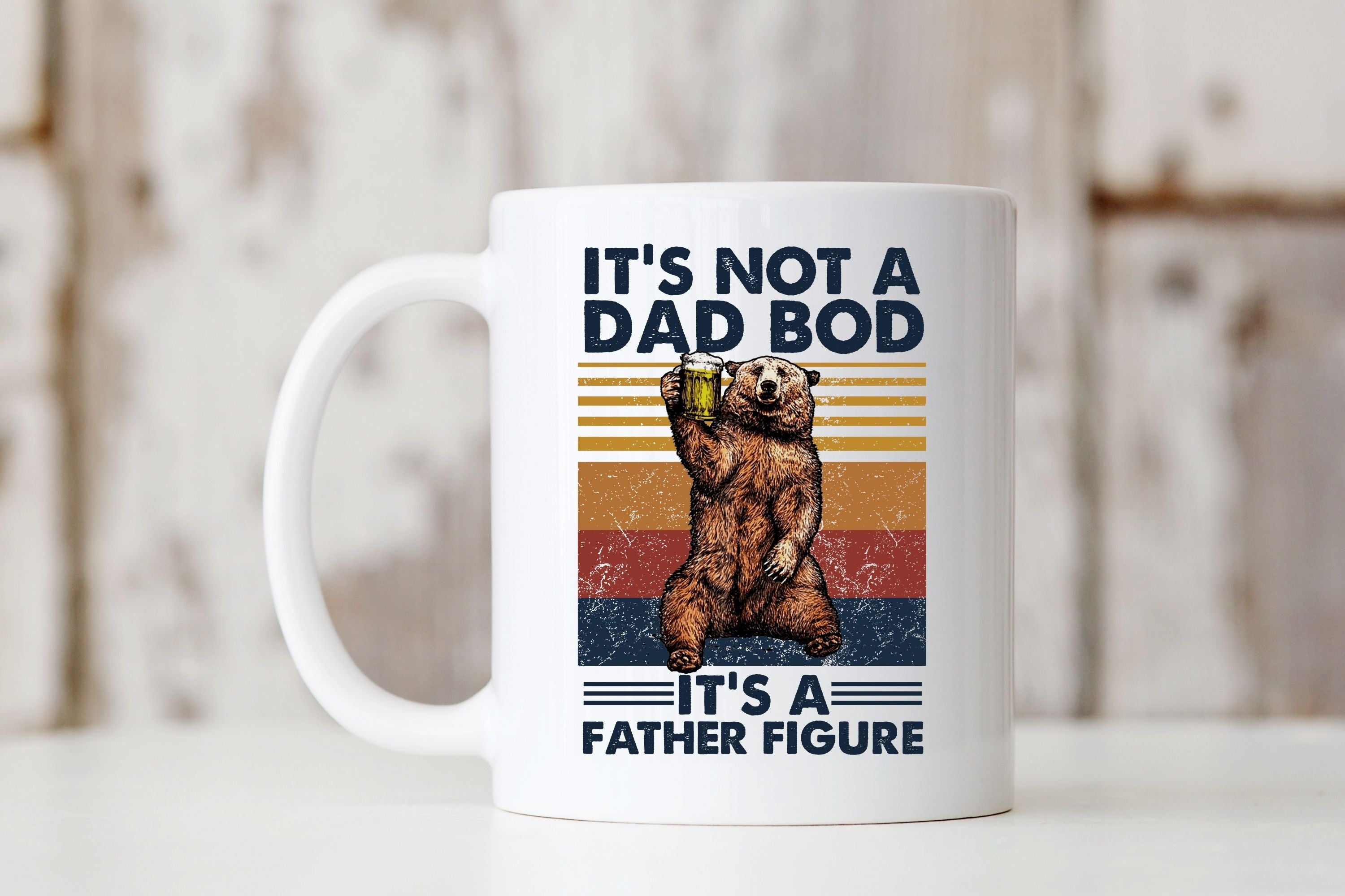 Picture of our All White 11oz Coffee Mug with Graphic of Bear Holding up a Beer, It's Not a Bod, It's a Father Figure on front of mug