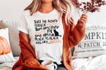 Load image into Gallery viewer, Blond young woman in burnt orange cardigan with white t-shirt with Twist the bones spell from Hocus pocus
