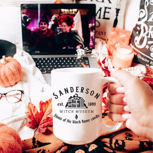 Picture of All White 15oz Coffee Mug for Halloween with graphic of Sanderson Witch Museum Logo in Black