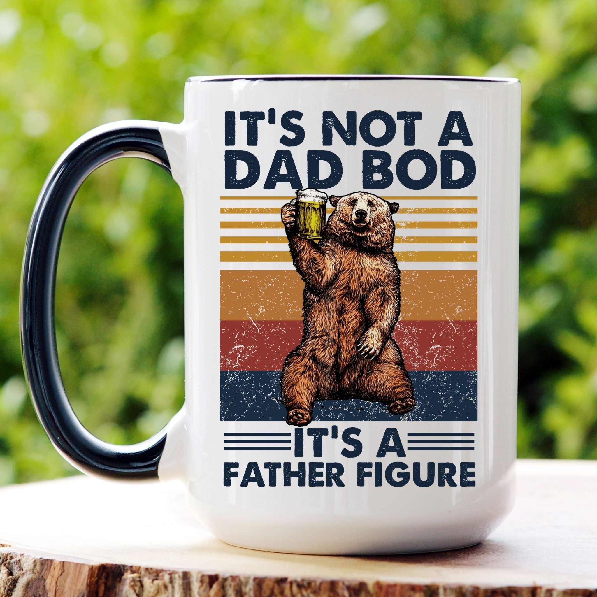 Picture of our 15oz Black Handle Coffee Mug with Graphic of It's Not a Bod, It's a Father Figure Retro Distressed  Bear Holding a Beer on front of mug.