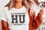 Load image into Gallery viewer, Picture of young woman in cardigan with our Halloweentown University T-Shirt.  This tee is available in more sizes and colors. Pictured in White
