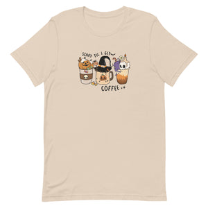 Soft cream women's t-shirt for halloween with graphic of three coffee drinks, one with a pumpkin, the center with a witches hat and the last with a skull candle.